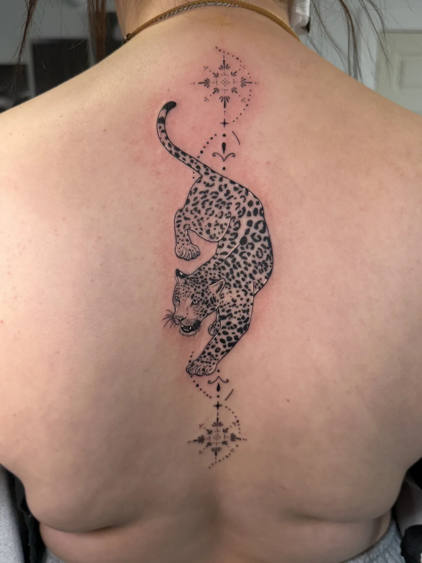 Ornamental leopard tattoo
