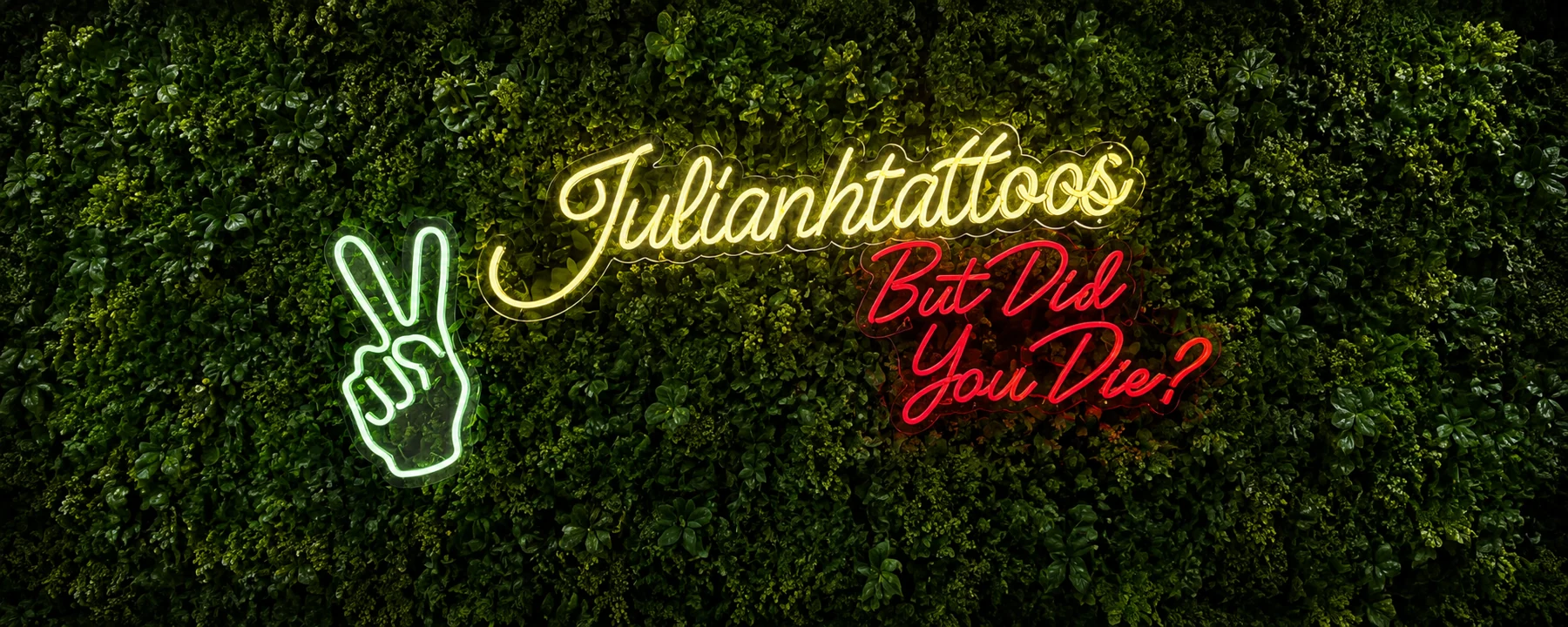 Julian’s recreated green studio wall with the neon words Julianhtattoos and But Did You Die?